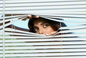 Woman looks out a window,